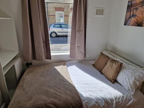 a bed in a small room with a window at 18 Horner Street in York