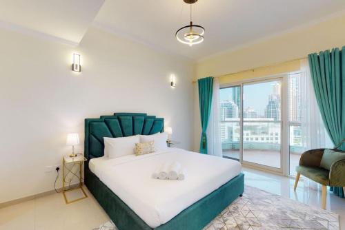 a bedroom with a large bed and a large window at The Zen Tower - Vacationer in Dubai
