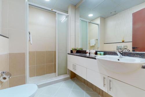a bathroom with a sink and a shower at The Zen Tower - Vacationer in Dubai