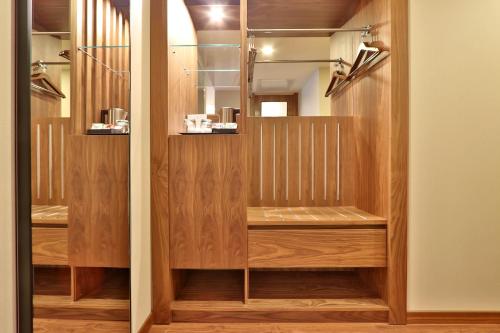 a dressing room with wooden shelves and a mirror at TURIM Iberia Hotel in Lisbon
