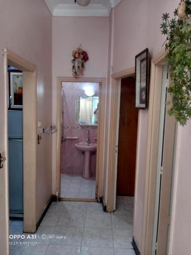 a hallway of a bathroom with a sink and a toilet at الوحيد برأس البر in ‘Izbat al Burj