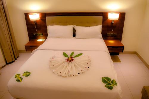 a hotel room with a bed with a flower on it at Grand Hotel Juba in Juba
