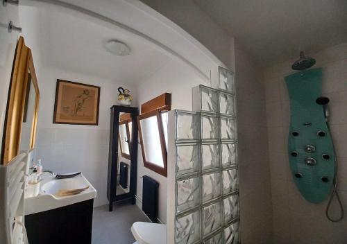 a bathroom with a sink and a green skateboard on the wall at Habitaciones en El Atico de Tona mirando a la Bahia de Santander in Santander