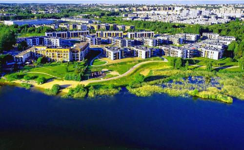 an aerial view of a large city next to a body of water at Gilužio Rivjera in Vilnius