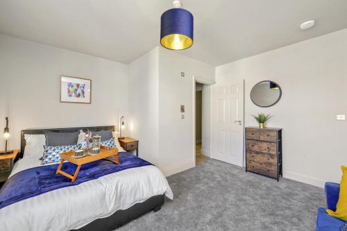 a bedroom with a bed with a table on it at Stone Pit Apartments in Golborne