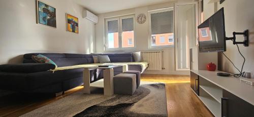 a living room with a couch and a table at AVA Apartment Istočno Sarajevo in Lukavica