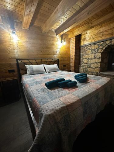 a bedroom with a bed with two blue towels on it at Къща за гости ,,Горски полъх” in Zaychari