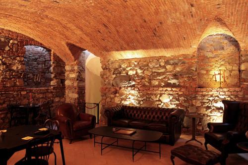 a living room with a couch and a stone wall at Villa Lucini 1886 "La Dolcevita" Cottage 2, close to Lake Como and Milan in Calco