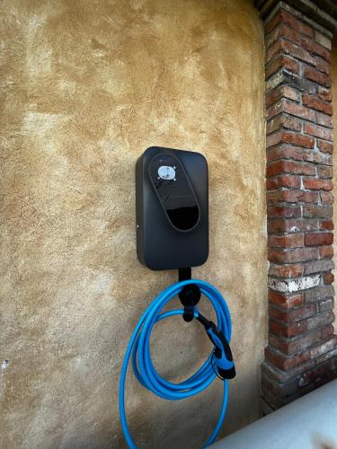 a hose is hooked up to a wall with a meter at Dobrinja Residence Villas Lopar in Marezige