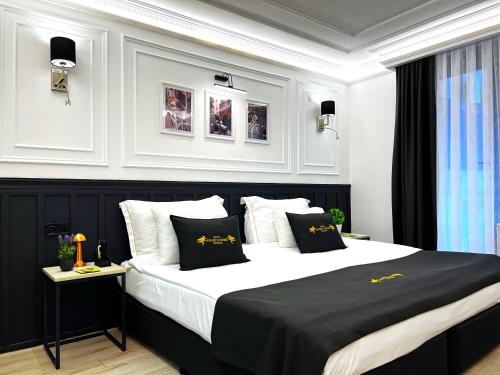 a bedroom with a large bed with black and white pillows at Angel's Home Hotel - Angel Group Hotels in Istanbul