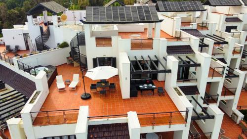 an aerial view of a house with a roof at Exclusive luxury frontline beach penthouse Casares del mar - Estepona in Casares