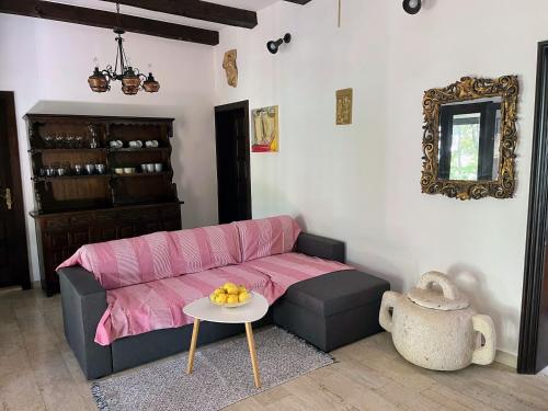 a living room with a pink couch and a table at Holiday Home Božo in Korčula