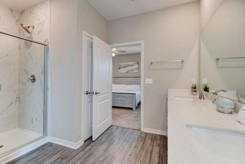 a bathroom with a shower and a sink and a tub at New St Augustine Waterview Home in Saint Augustine
