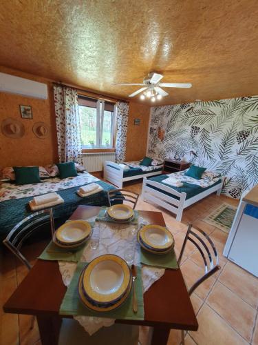 a living room with a table with plates on it at Szyszkowy Domek in Milejczyce