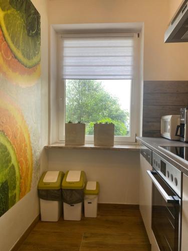 a kitchen with two stools and a window at FeWo Marielle in Seeboden