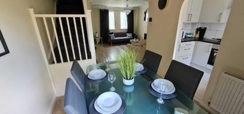 a dining room table with chairs and a blue table top at Dreals Apartments in Stevenage