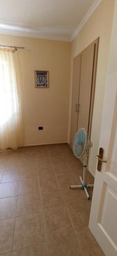 an empty room with a chair and a door at Villa family Bitri in Piqeras