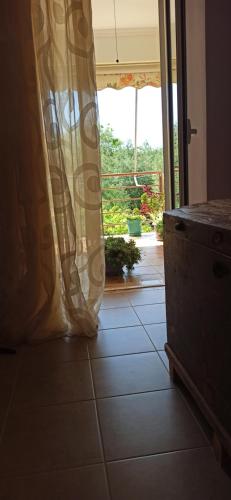 a room with a door open to a patio at Villa family Bitri in Piqeras