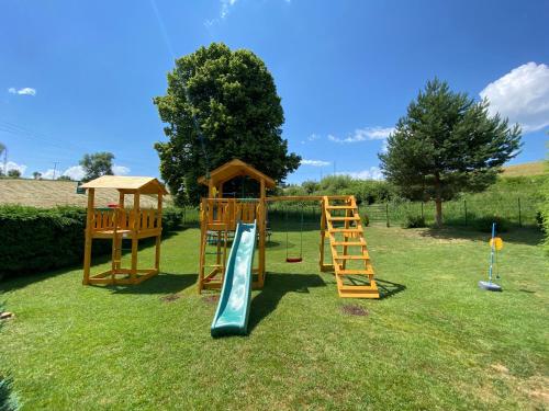 a playground with a slide and a play structure at Chata Pepa in Bobrovník