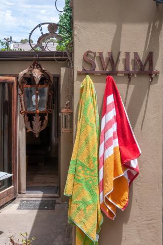 two towels are hanging on the side of a building at Art Box in Greyton