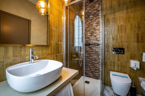 a bathroom with a sink and a shower and a toilet at Hotel Duomo Firenze in Florence