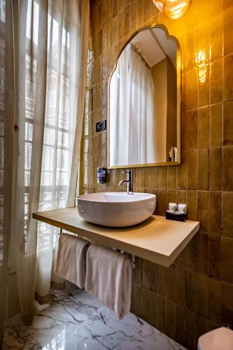 a bathroom with a sink and a mirror at Hotel Duomo Firenze in Florence