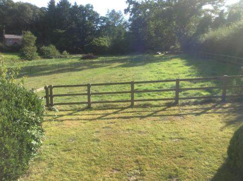 a wooden fence in the middle of a field at Secluded cosy cottage in Newbury