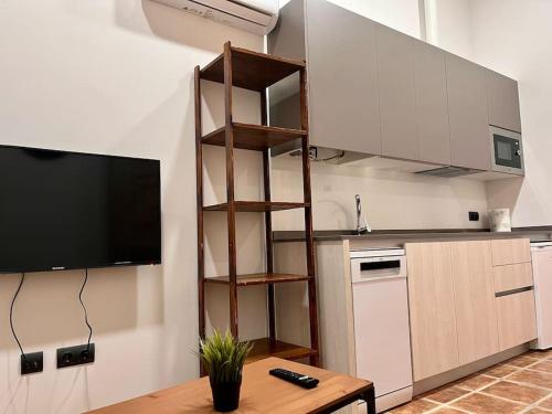a kitchen with a table and a television in a room at Apartamento Villanubla in Villanubla
