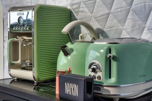 a green toaster sitting on top of a counter at luxury dome tents ikaria ap'esso in Raches