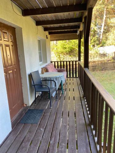 a porch with a table and chairs on a deck at Aga Kotkowo in Łukta