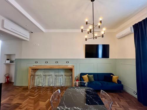 a living room with a blue couch and a fireplace at Be Your Home - Guest House Fuori Dal Porto in Civitavecchia