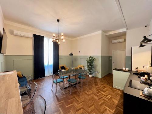 a dining room and living room with a table and chairs at Be Your Home - Guest House Fuori Dal Porto in Civitavecchia