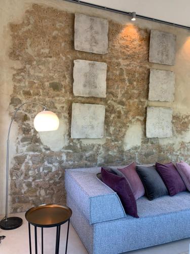 a living room with a couch and a stone wall at Scheier (Ferienwohnungen) in Perl