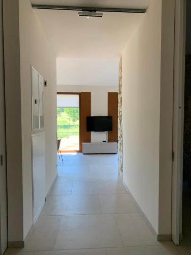 a hallway with white walls and a television in a house at Scheier (Ferienwohnungen) in Perl