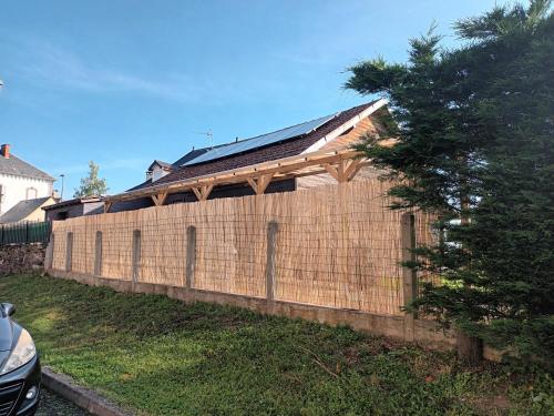 a brick wall with a roof on top of it at Le Miraillet, gîte in Saint-Illide