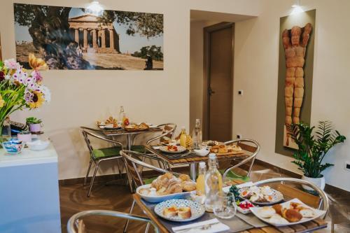 a table with plates of food in a room at Domus Cese in Agrigento