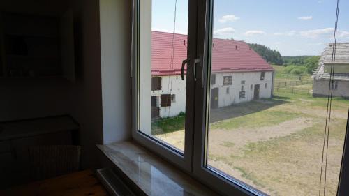 a window with a view of a building at Pensjonat Kowalski in Łubowo