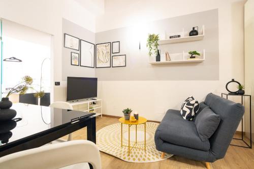 a living room with a couch and a table at Central with hydromassage shower and elevator in Perugia