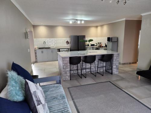 a kitchen with a island in a living room at Bella Vista at Village-Living in Koringberg
