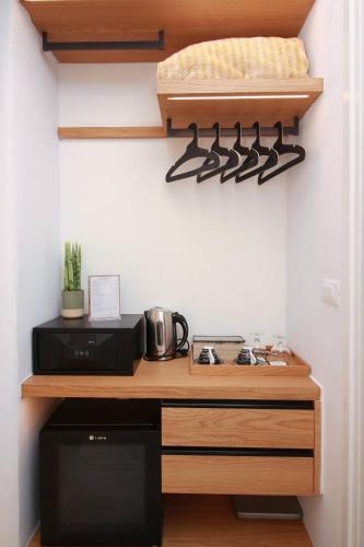a kitchen with a counter with a stove top oven at Harmony Boutique Hotel in Mýkonos City