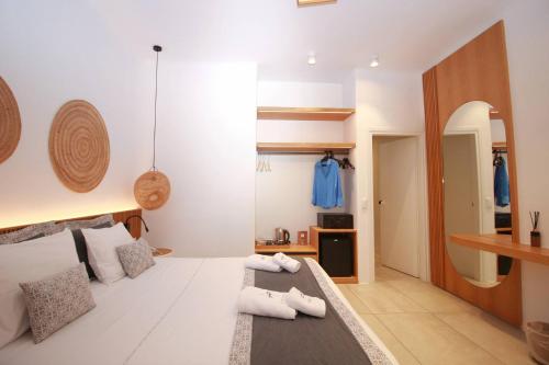 a room with a bed with towels on it at Harmony Boutique Hotel in Mýkonos City