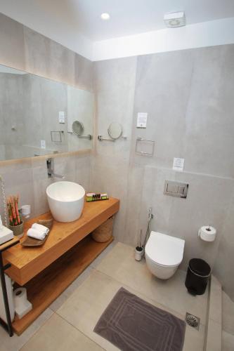 a bathroom with a sink and a toilet at Harmony Boutique Hotel in Mýkonos City