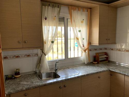 a kitchen with a sink and a window at Apartamento dúplex Cabo de Gata in El Cabo de Gata