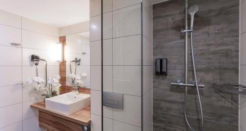 a bathroom with a shower and a sink at PLAZA Premium Columbus Bremen in Bremen