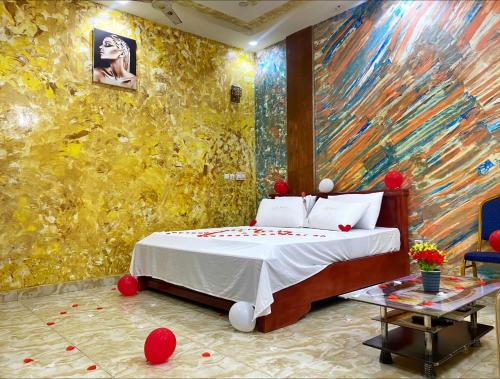 - une chambre avec un lit orné d'une peinture murale dans l'établissement Glory Palace Hotel, à Cotonou