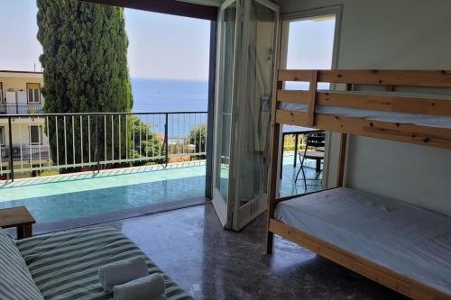 a bedroom with a bunk bed and a balcony with a pool at Vista Bella House in Sanremo