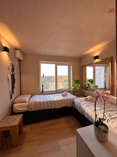 a bedroom with two beds and a window at Sea View Nook in Porthtowan