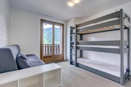 Cette chambre dispose de lits superposés, d'un canapé et d'une fenêtre. dans l'établissement Les Césaries A5, à Morzine