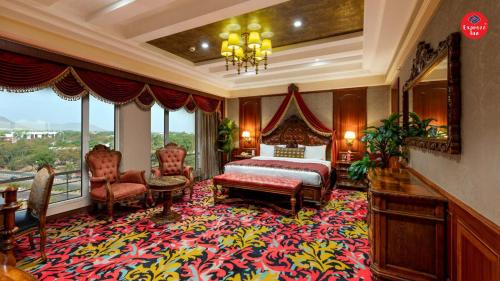 a bedroom with a bed and a large rug at Express Inn The Business Luxury Hotel in Nashik