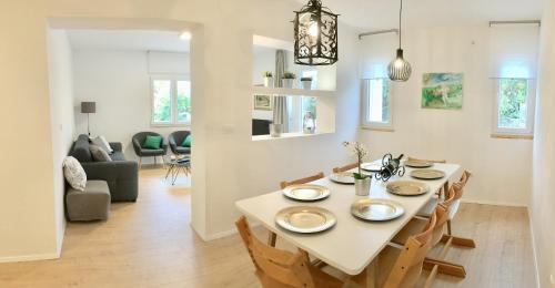 a dining room and living room with a table and chairs at Villa Sol Necujam - private pool and 30m from the beach in Nečujam